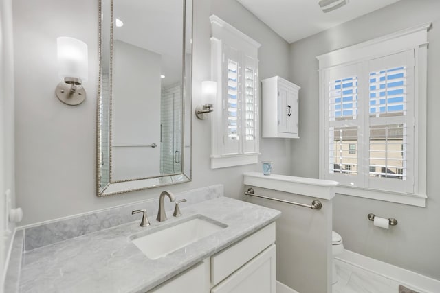 bathroom featuring vanity and toilet