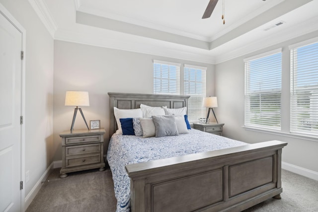 carpeted bedroom featuring ceiling fan, a raised ceiling, and crown molding