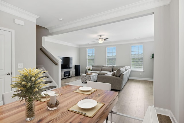 living room featuring light wood-type flooring, ceiling fan, and ornamental molding