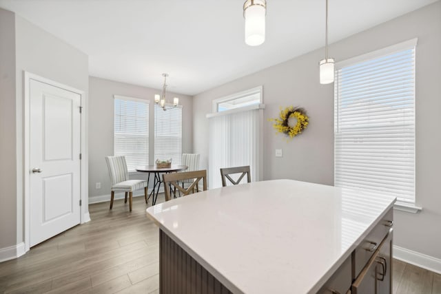 kitchen featuring a chandelier, a center island, hanging light fixtures, and wood-type flooring