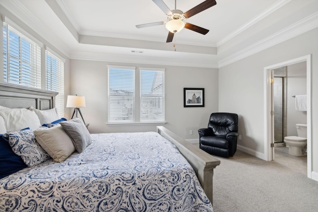 bedroom featuring ceiling fan, ornamental molding, multiple windows, and ensuite bath