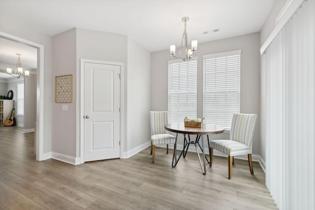 sitting room featuring light hardwood / wood-style floors and a notable chandelier