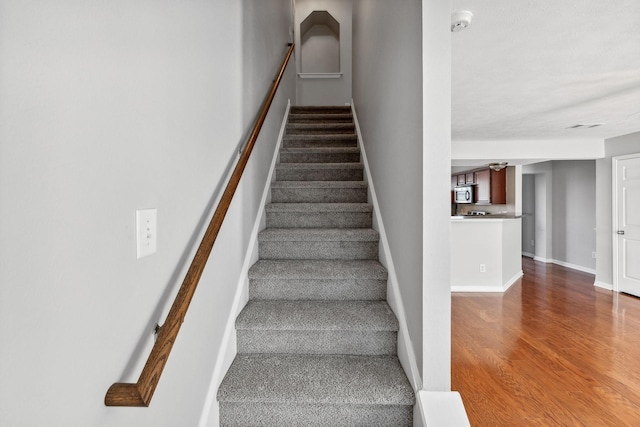 stairs with hardwood / wood-style flooring