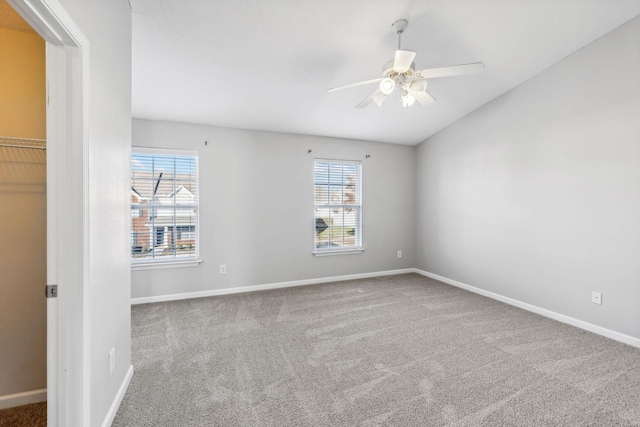 unfurnished room with ceiling fan, plenty of natural light, and carpet