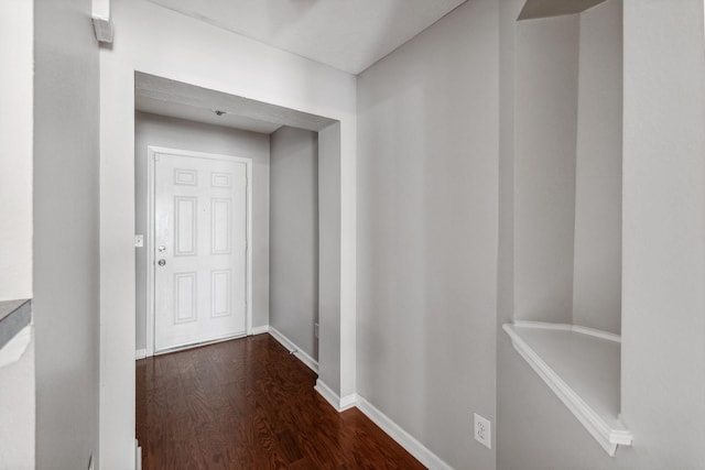 corridor with dark wood-type flooring