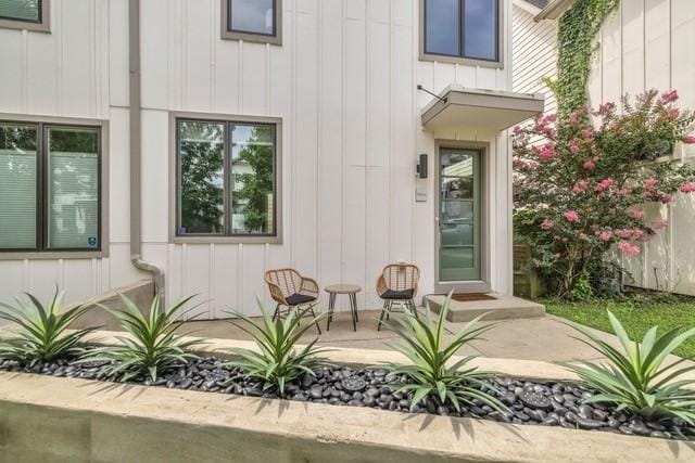 view of exterior entry with a patio