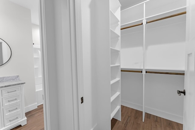 walk in closet with light wood-type flooring