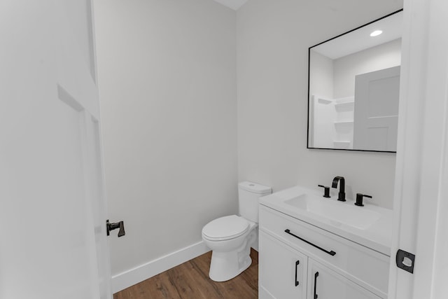 bathroom featuring hardwood / wood-style flooring, vanity, and toilet