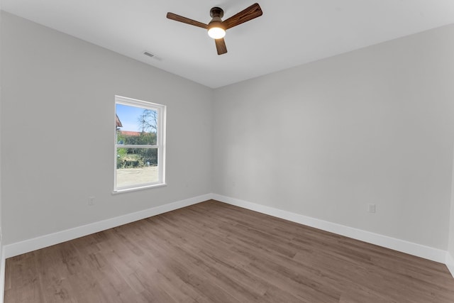 unfurnished room with hardwood / wood-style flooring and ceiling fan