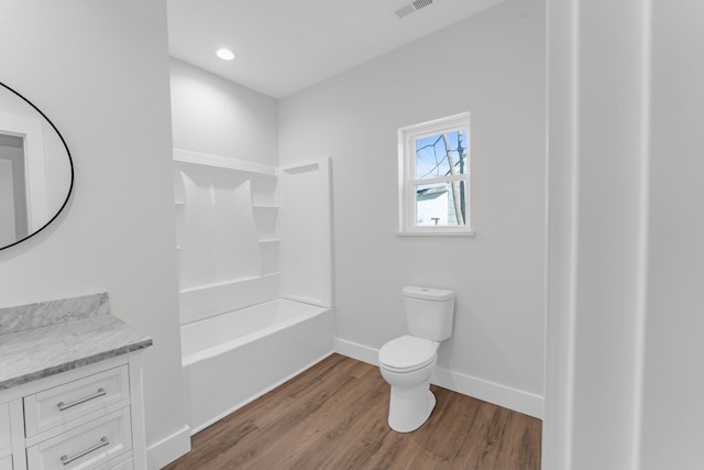 full bathroom featuring vanity, hardwood / wood-style flooring, toilet, and shower / bath combination