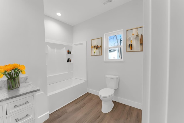 full bathroom featuring vanity, hardwood / wood-style flooring,  shower combination, and toilet