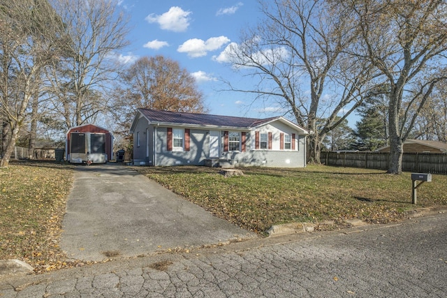 ranch-style home with a front lawn