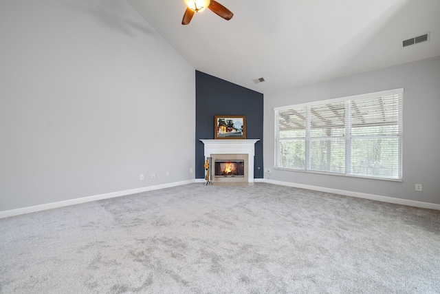 unfurnished living room featuring carpet flooring, ceiling fan, and vaulted ceiling