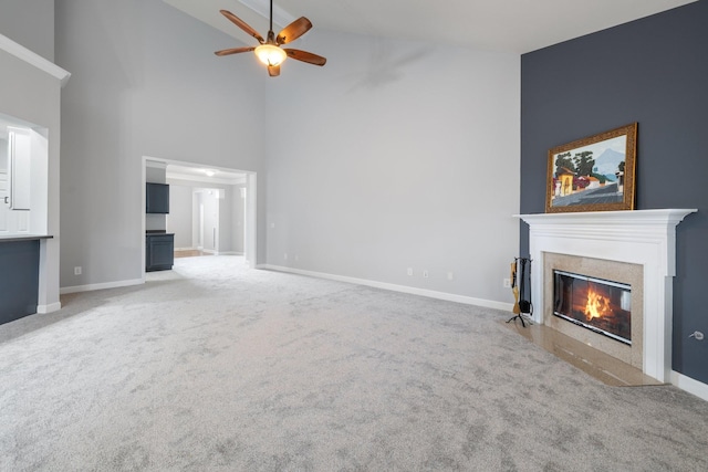 unfurnished living room with carpet flooring, high vaulted ceiling, and ceiling fan