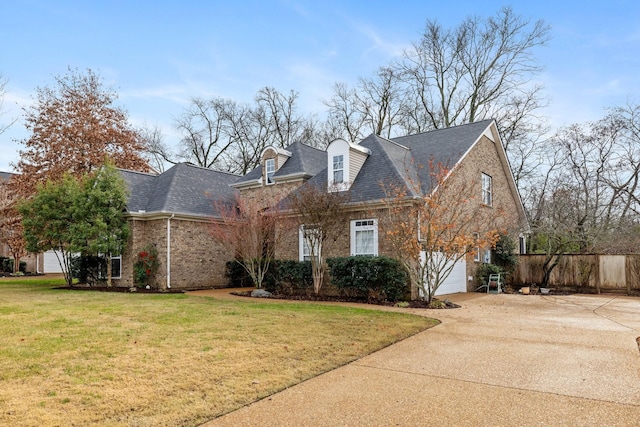 cape cod home with a front lawn and a garage