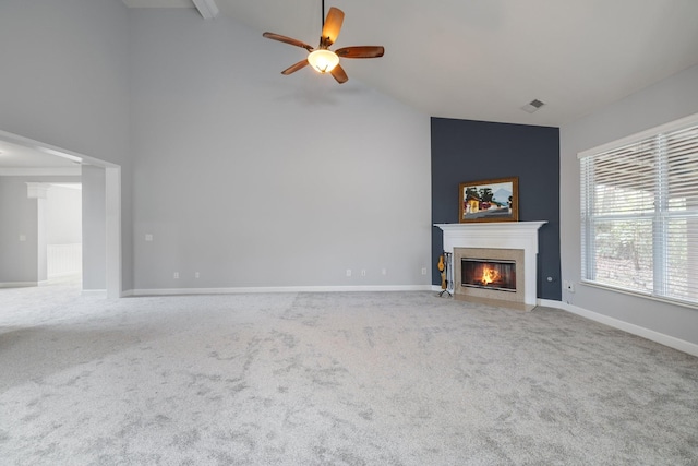 unfurnished living room featuring carpet, high vaulted ceiling, and ceiling fan