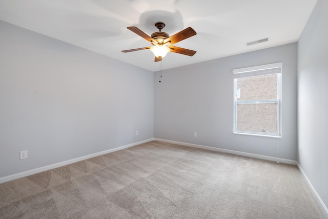 carpeted spare room with ceiling fan