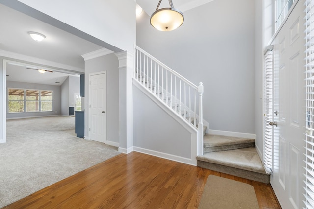 foyer entrance with hardwood / wood-style floors and crown molding