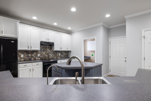 kitchen with sink, backsplash, crown molding, white cabinets, and black appliances