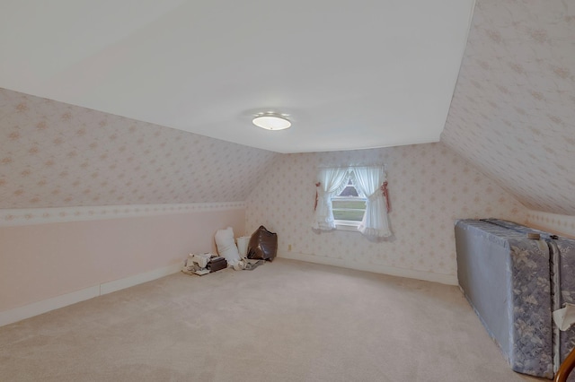 bonus room with light colored carpet and lofted ceiling