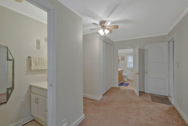 bathroom featuring ceiling fan, crown molding, and vanity