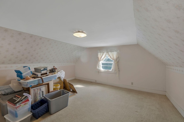 additional living space with carpet floors and vaulted ceiling