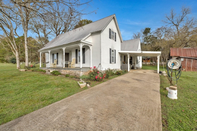 view of side of home featuring a yard, central AC unit, a porch, and a carport