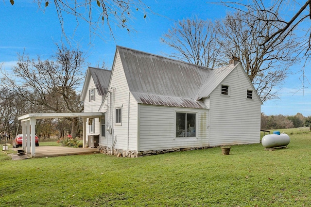 view of side of home with a yard