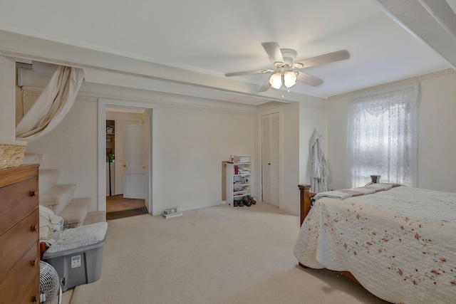 carpeted bedroom with ceiling fan and a closet