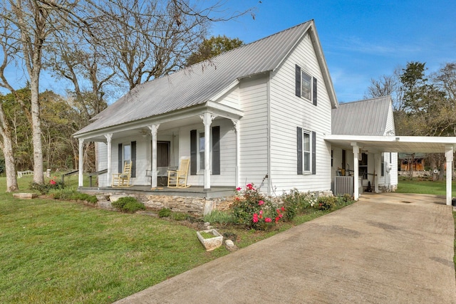 view of front of house with a porch, a carport, and a front lawn