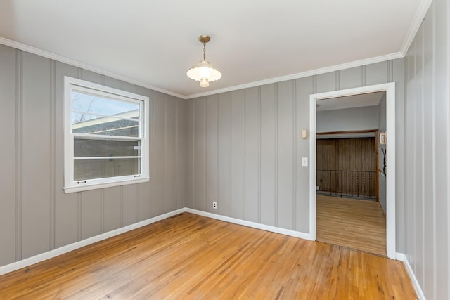 unfurnished room with light hardwood / wood-style flooring and ornamental molding