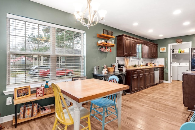 kitchen with a wealth of natural light, dark brown cabinets, hanging light fixtures, and independent washer and dryer