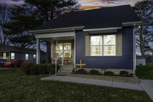 view of front of property featuring a lawn and a porch