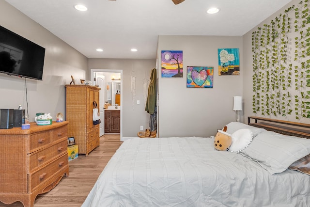 bedroom featuring light hardwood / wood-style flooring, ensuite bath, and ceiling fan