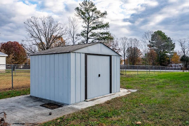 view of outdoor structure featuring a lawn