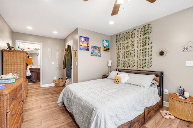 bedroom featuring ensuite bath, ceiling fan, and light hardwood / wood-style flooring