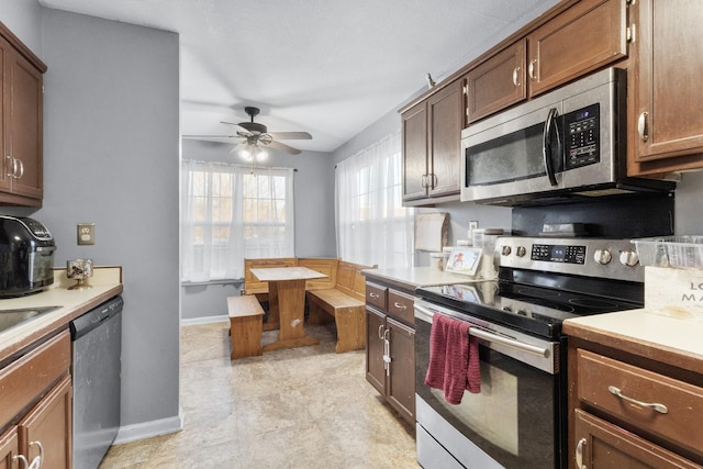 kitchen featuring ceiling fan and stainless steel appliances