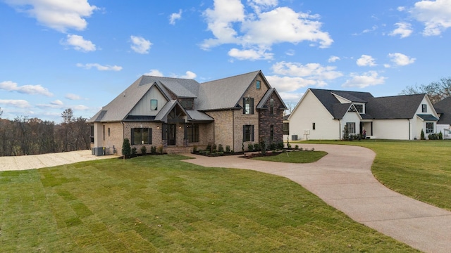 view of front facade with a front yard and central AC unit