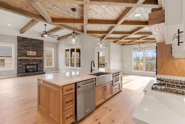 kitchen featuring a wealth of natural light, pendant lighting, and appliances with stainless steel finishes