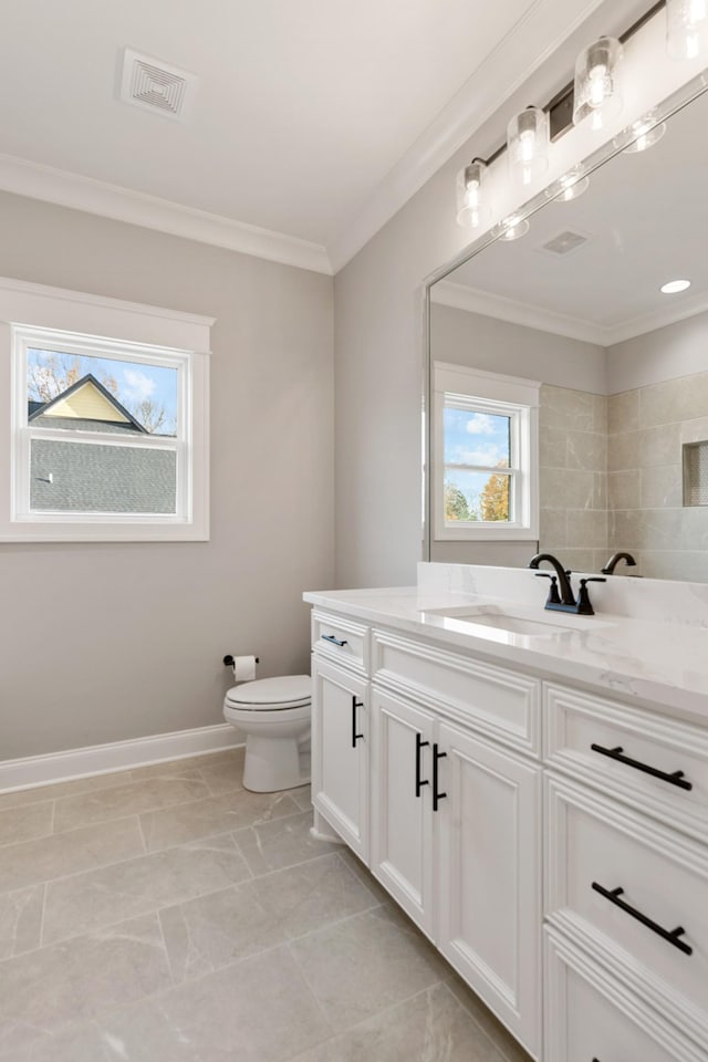 bathroom featuring tile patterned flooring, vanity, toilet, and ornamental molding