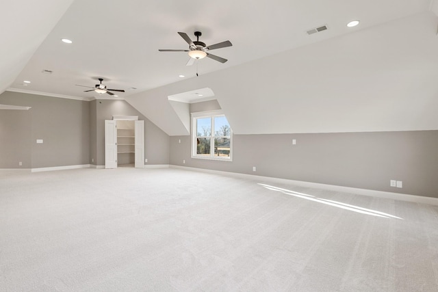 additional living space with ceiling fan, light colored carpet, and lofted ceiling