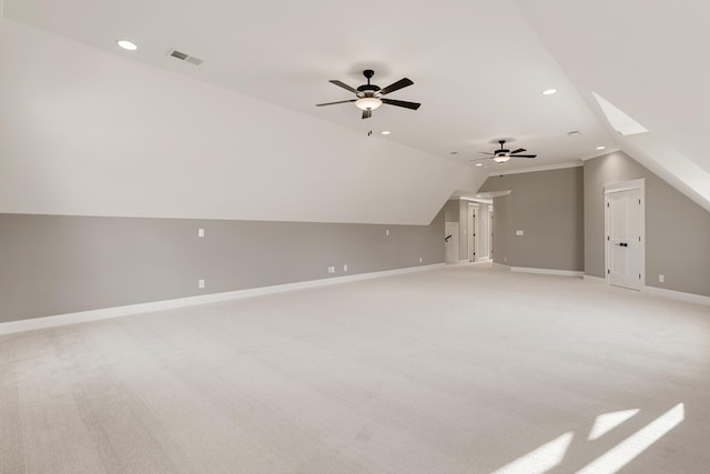 additional living space with ceiling fan, light colored carpet, and lofted ceiling