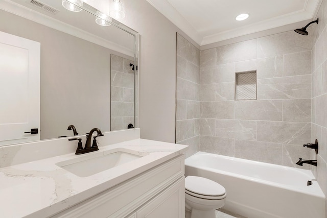 full bathroom featuring tiled shower / bath combo, toilet, crown molding, and vanity