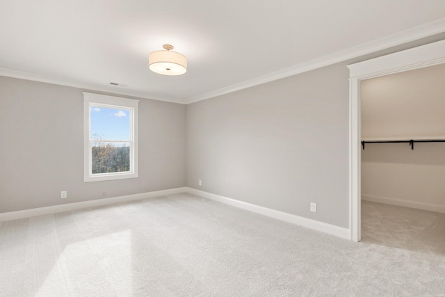 spare room featuring light carpet and ornamental molding