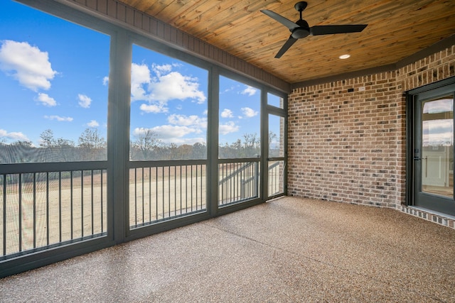 unfurnished sunroom with ceiling fan and wooden ceiling