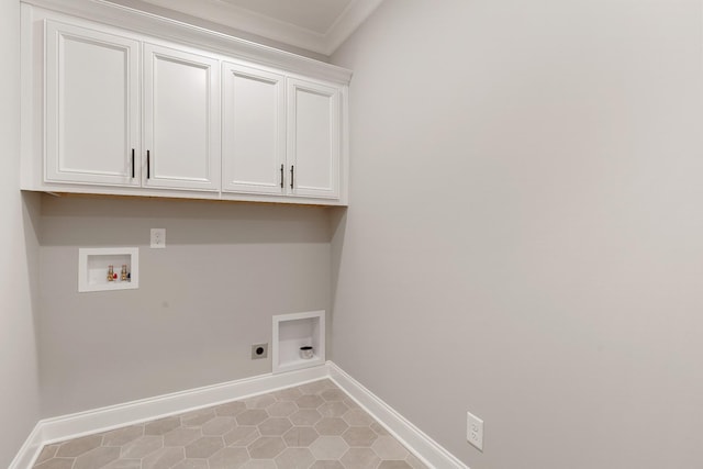 washroom featuring cabinets, hookup for an electric dryer, hookup for a washing machine, light tile patterned flooring, and ornamental molding