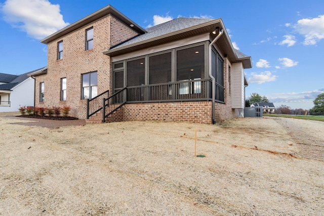 back of property with a sunroom