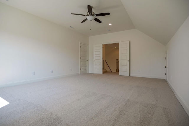 unfurnished bedroom featuring light carpet, ceiling fan, and lofted ceiling