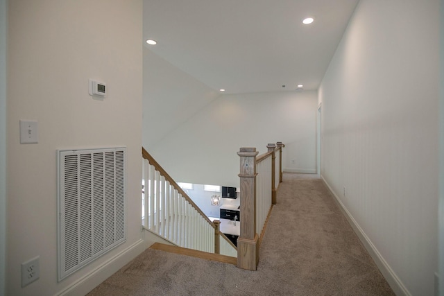 staircase featuring carpet flooring and vaulted ceiling