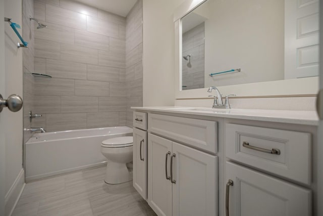 full bathroom with vanity, tiled shower / bath combo, and toilet